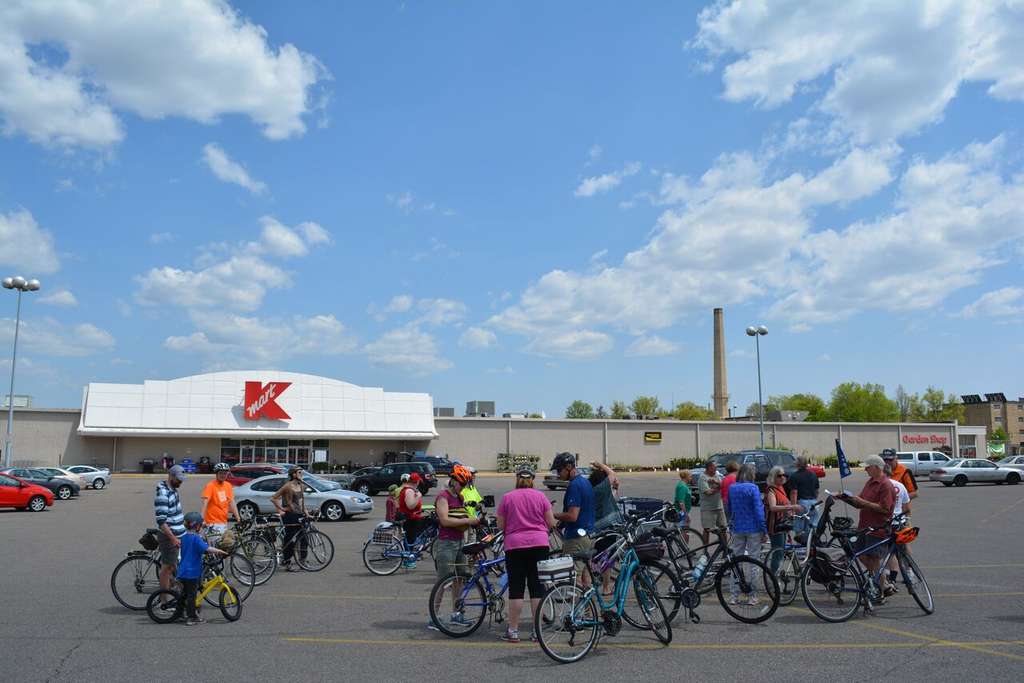 p and Donate by Bike participants gathered outside one of the stores
