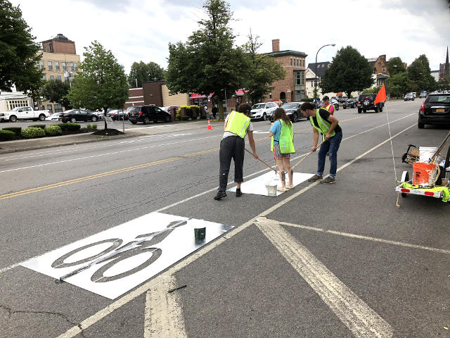 photo of volunteers with bike trailer in background