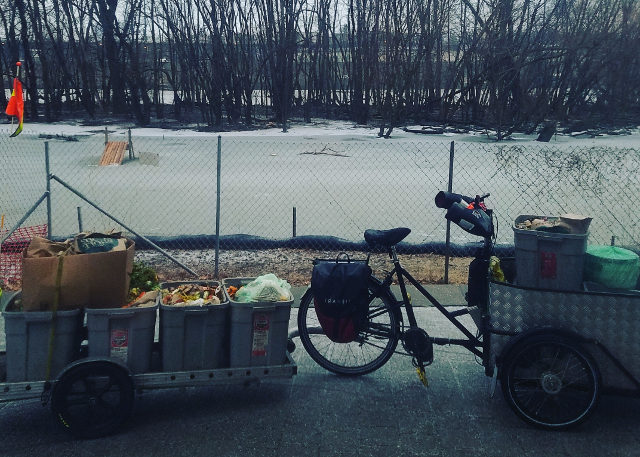 trike and trailer parked by frozen lake in winter