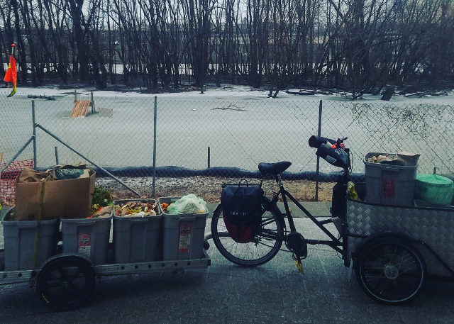 trike and trailer parked by frozen lake in winter
