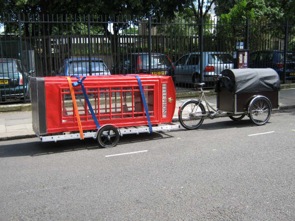 cargo trike and trailer carrying the phone booth
