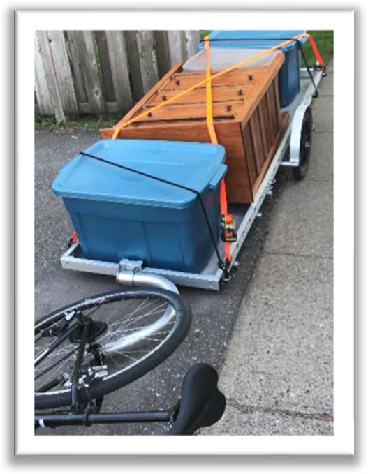 front view of trailer loaded with plastic bins and clothes dresser
