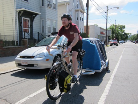 Gentle Giant employee Max carrying a loveseat on a Bikes At Work 64AW bicycle trailer