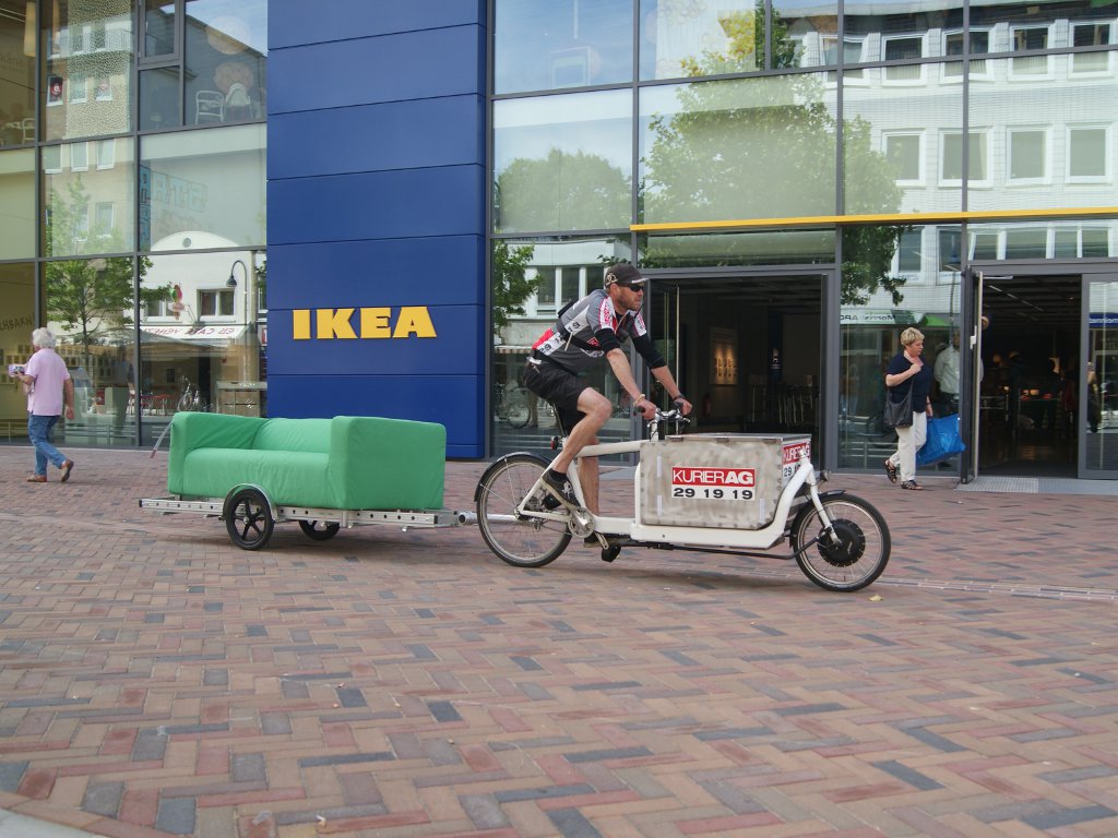 carrying sofa in front of Ikea store