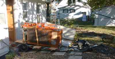 loading old refrigerator onto trailer