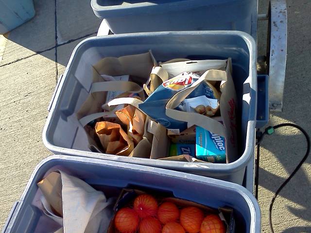 two bags of groceries fit perfectly inside one of the trailer's bin