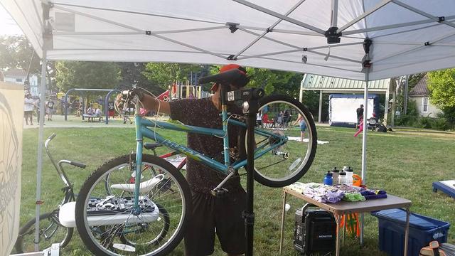 photo of mechanic working on bicycle at event
