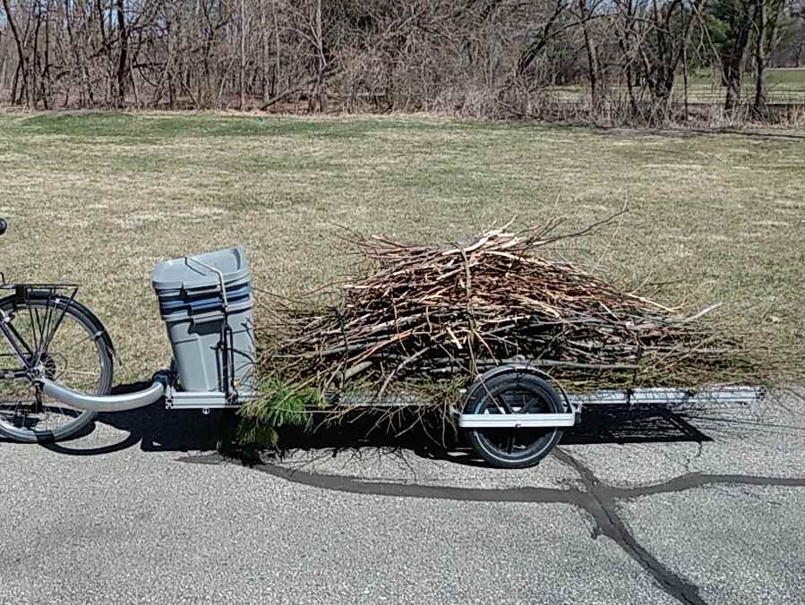 96B trailer loaded with a stack of bins and pile of brush