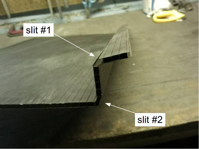 corrugated plastic panel after slitting opposite faces of the panel